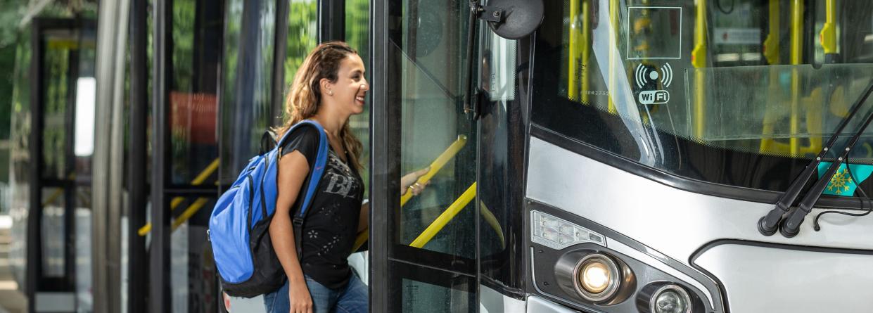 Photo of a woman boarding a bus.