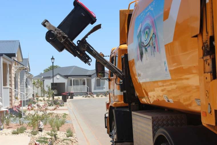 Photo of a truck lifting a wheelie bin