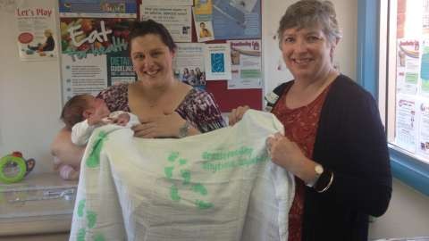  Mum Kristy Cranmer and 2 week old son Joshua receiving their wrap from Maternal and Child Health Nurse Judy Duff.