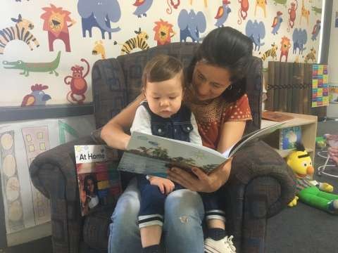 20-month-old Rafael Rodriguez-Saenz and mother Sandra Saenz reading one of the new multilingual books