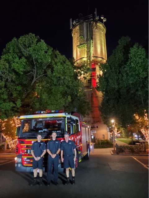 Fire Rescue Victoria showing support to National Road Safety Week in front of the Mooroopna Water Tower lit up yellow.