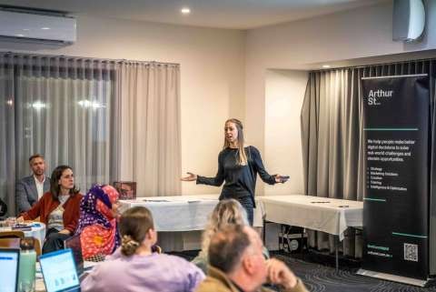 A presenter addressing attendees
